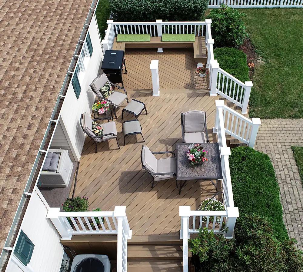 Aerial view of a multi-level Coconut Husk composite deck with white vinyl railing and built-in bench seating in Tiltonsville, Ohio.