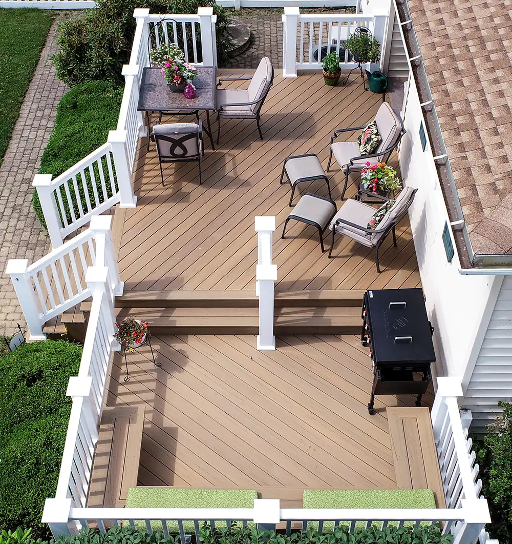 Prime+ Coconut Husk composite deck with diagonal decking, white vinyl railing, and multiple outdoor seating areas in Tiltonsville, Ohio.