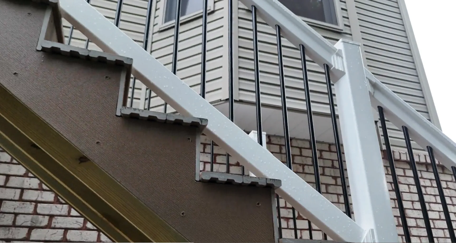 White vinyl deck railing with black spindles on a composite deck in Wheeling, WV