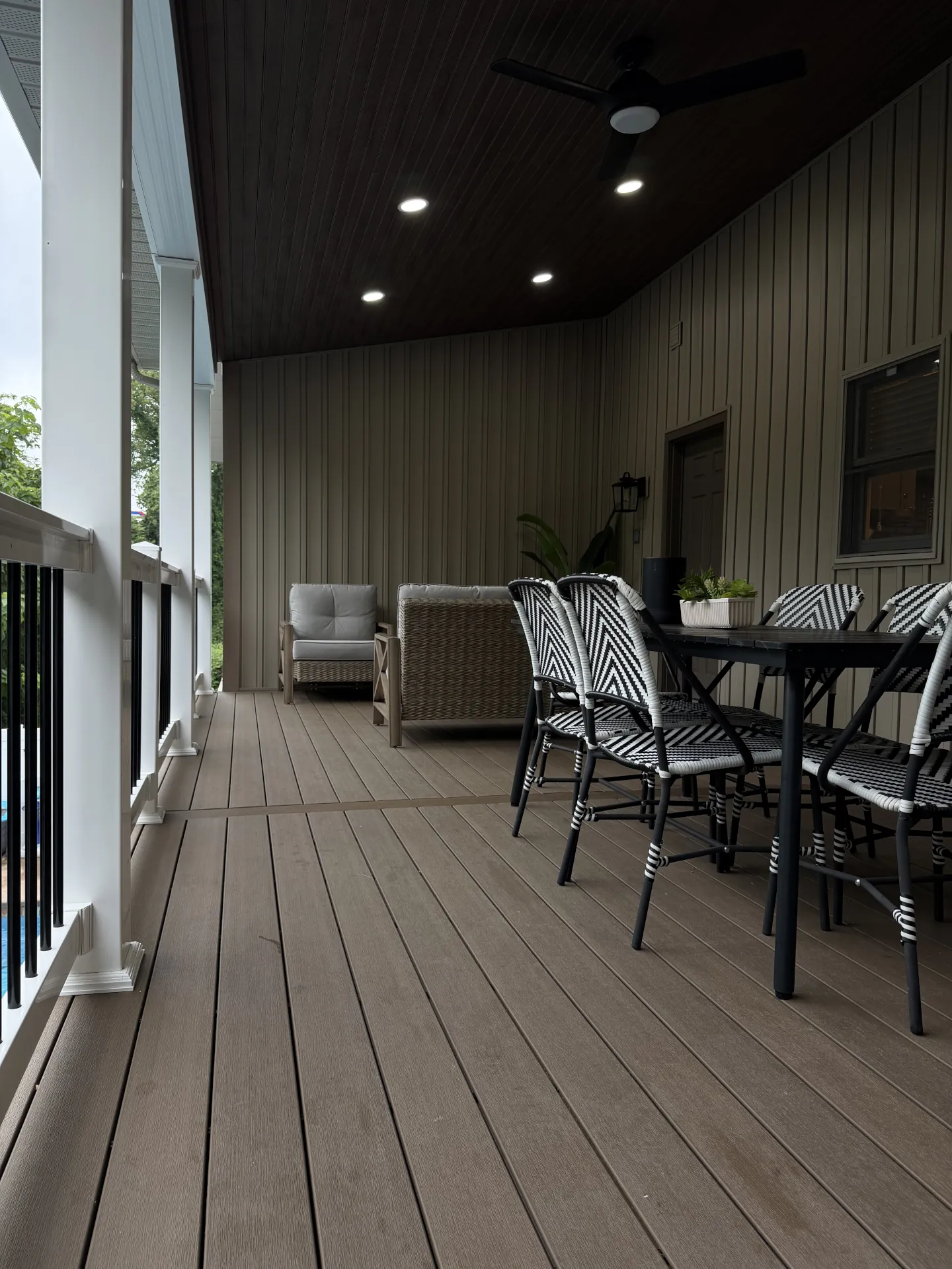 Covered Dark Oak composite deck with dining and seating space in Wheeling, WV