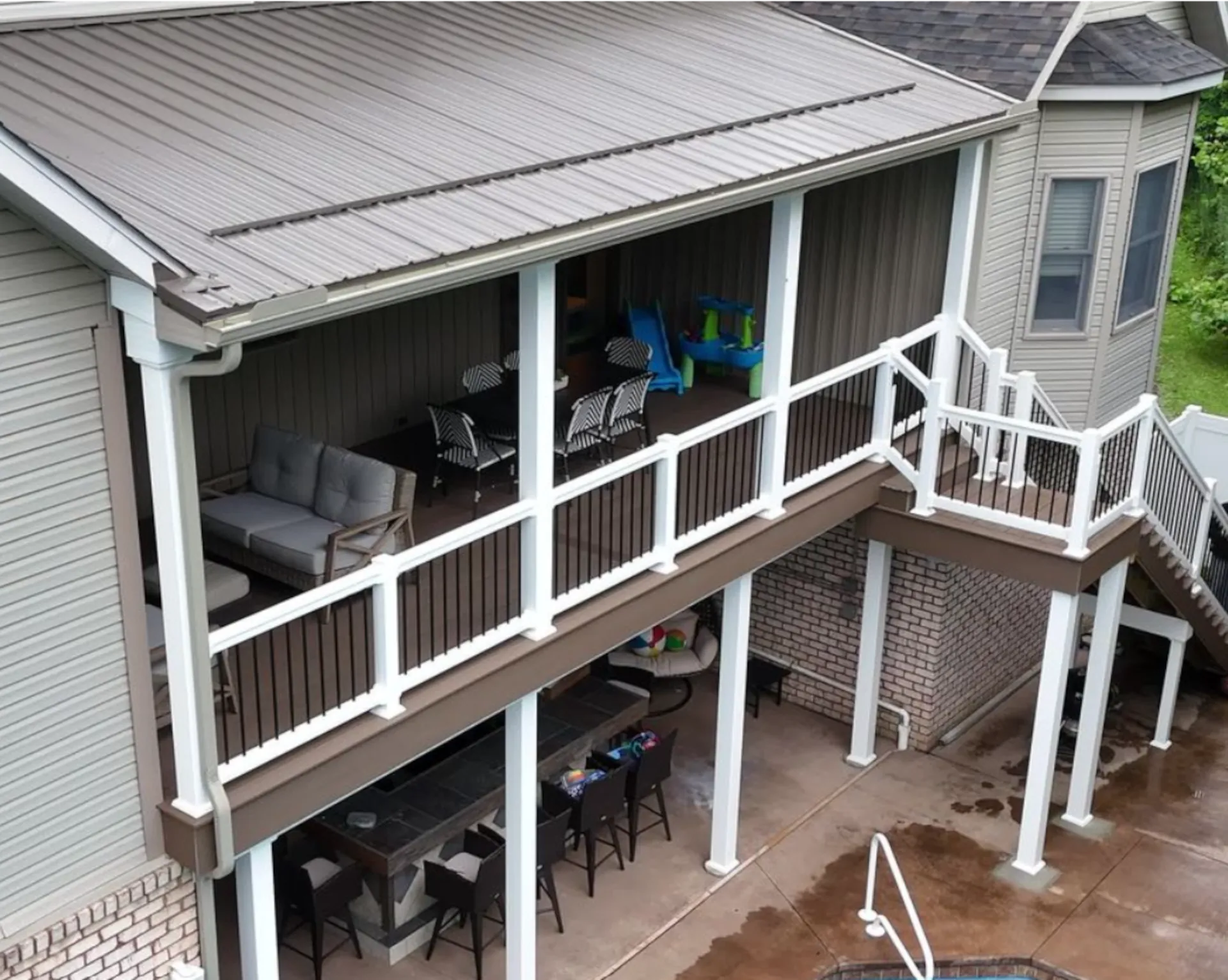 Elevated covered composite deck with white railing and usable space underneath in Wheeling, WV