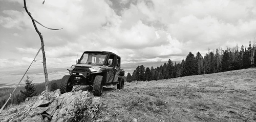 an ORV Extraction vehicle perched atop rough terrain in the mountains.