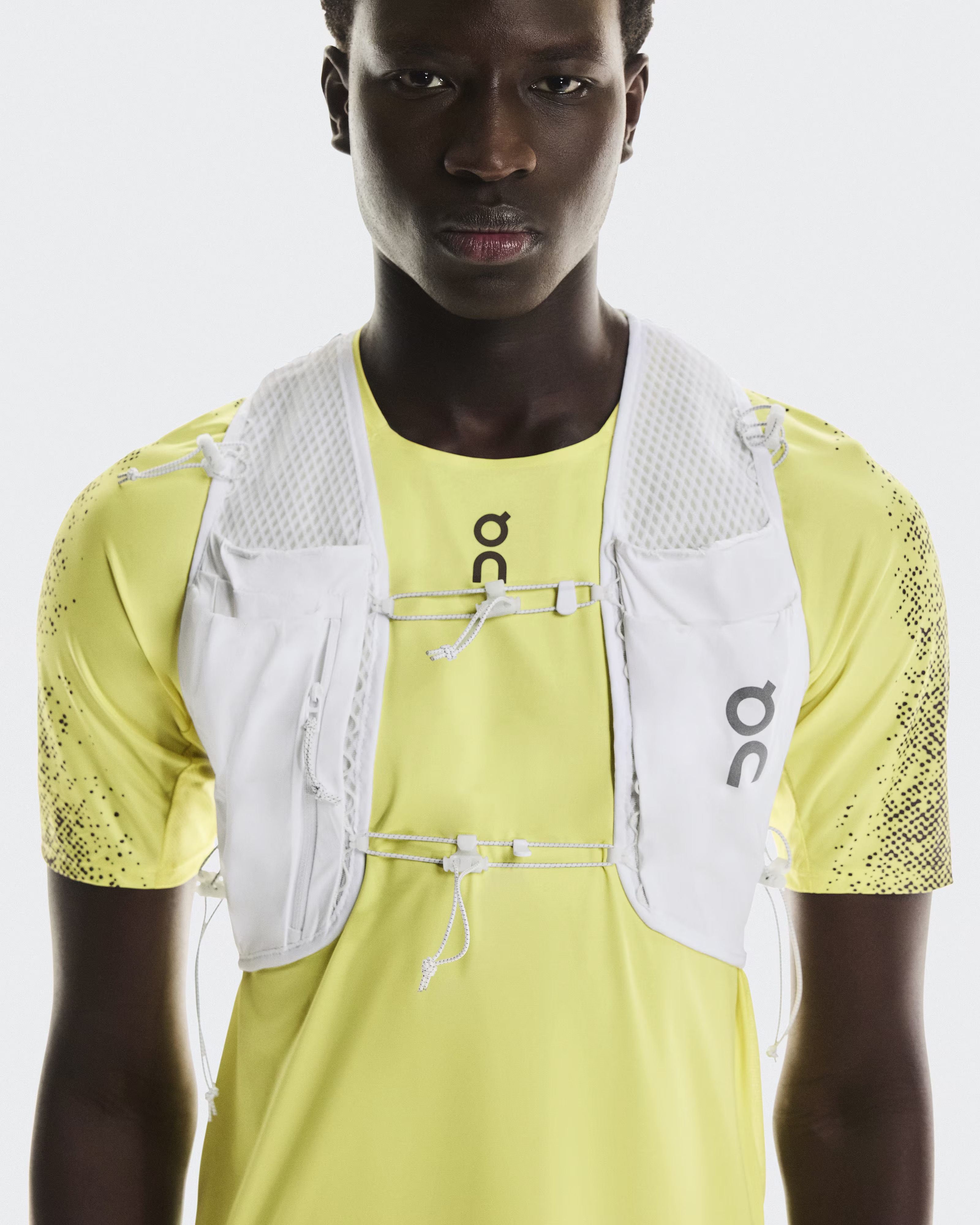 On Ultra Vest Pro in white seen displayed on a male model