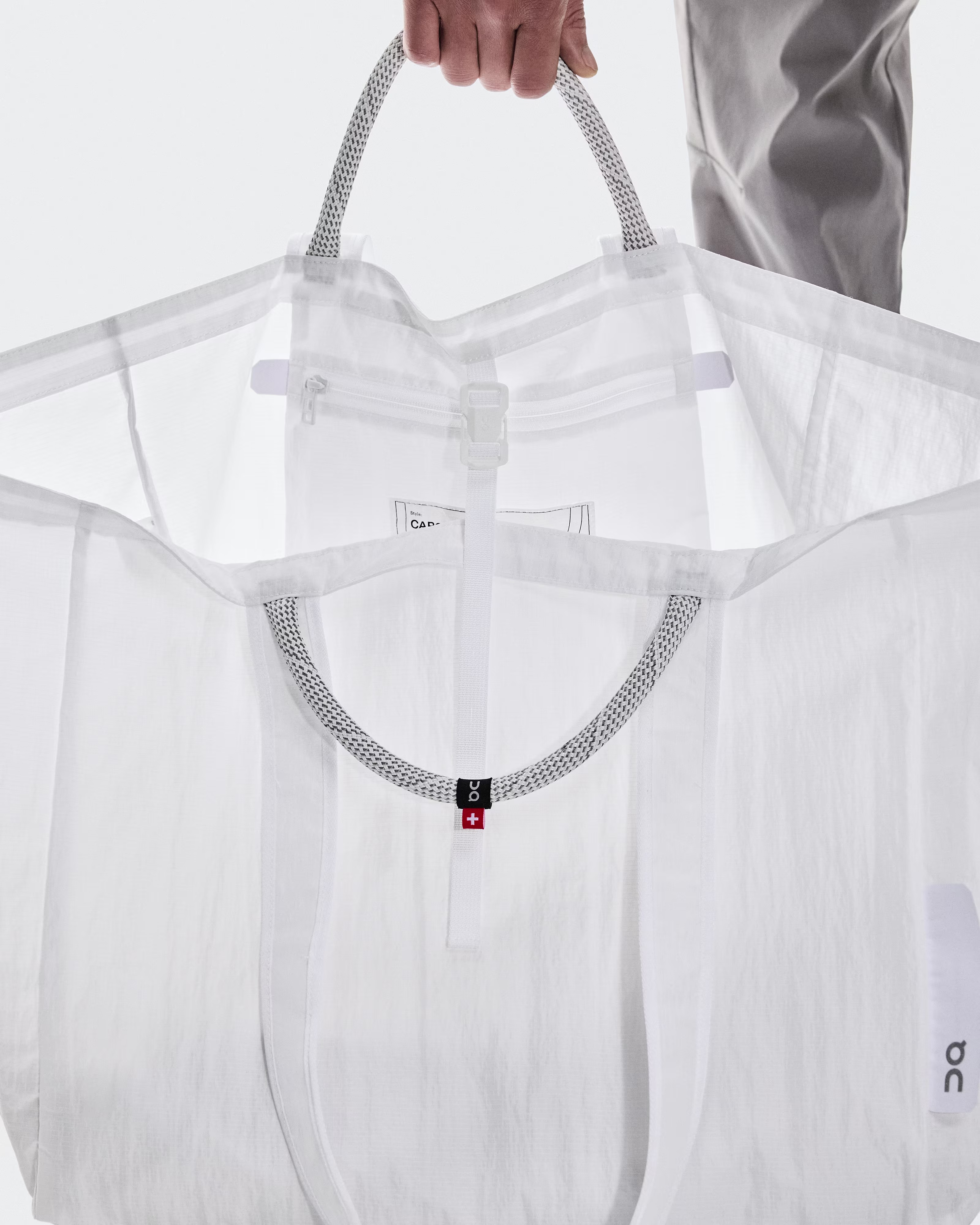 Close up images of On Cargo Pack 60L White oversized bag including details like handles and pockets