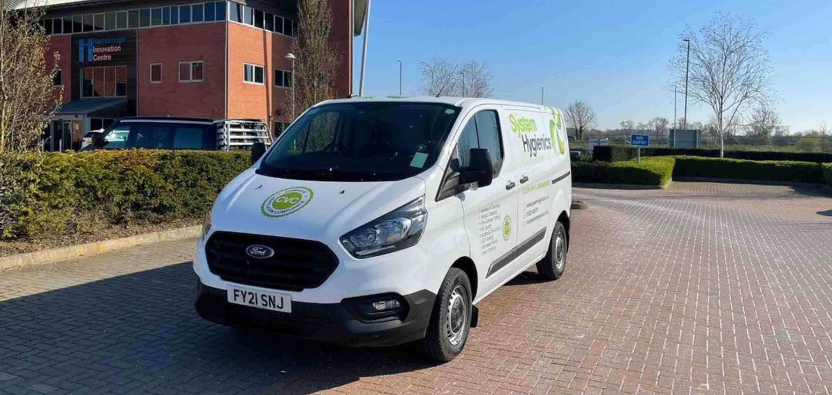 A System Hygienics van parked outside of a building