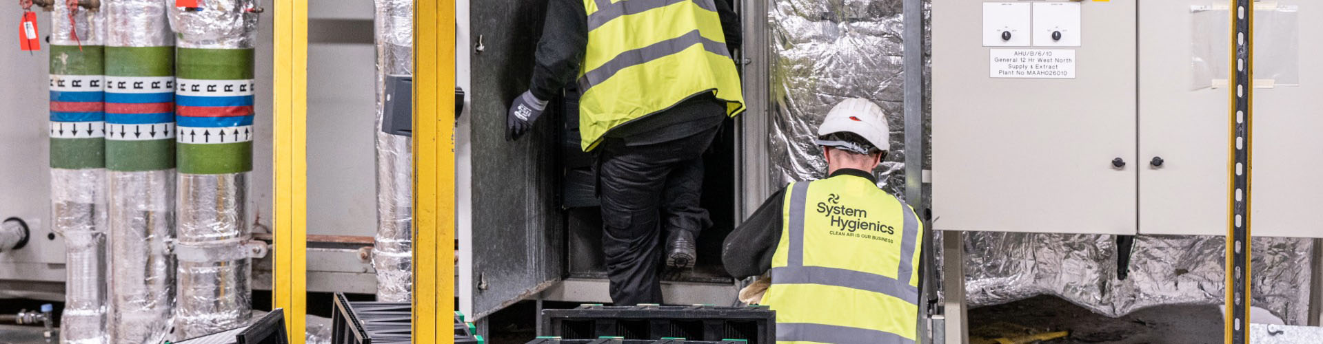 System Hygienics engineers conducting fire damper testing and ventilation system inspection.