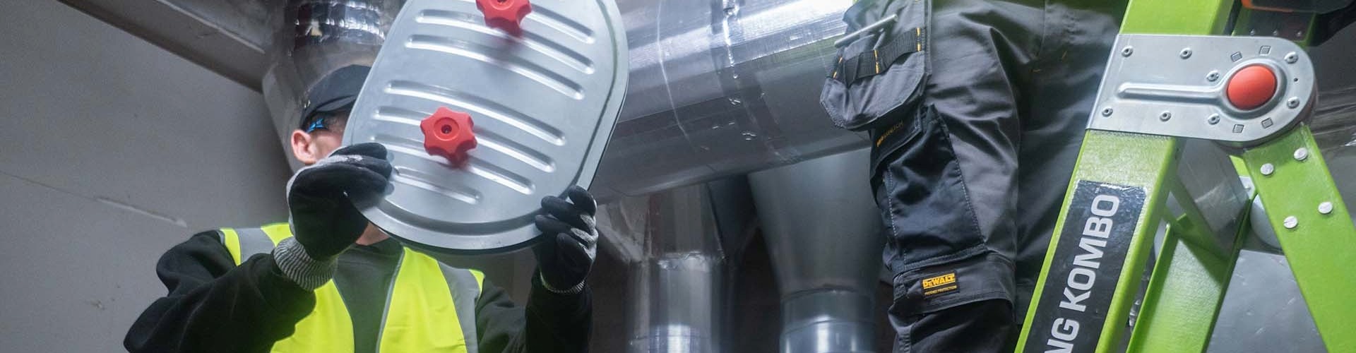 Engineer testing fire damper in ventilation system for BS9999 compliance - System Hygienics service.