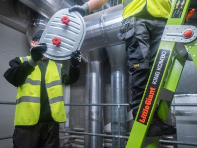 Engineer testing fire damper in ventilation system for BS9999 compliance - System Hygienics service.