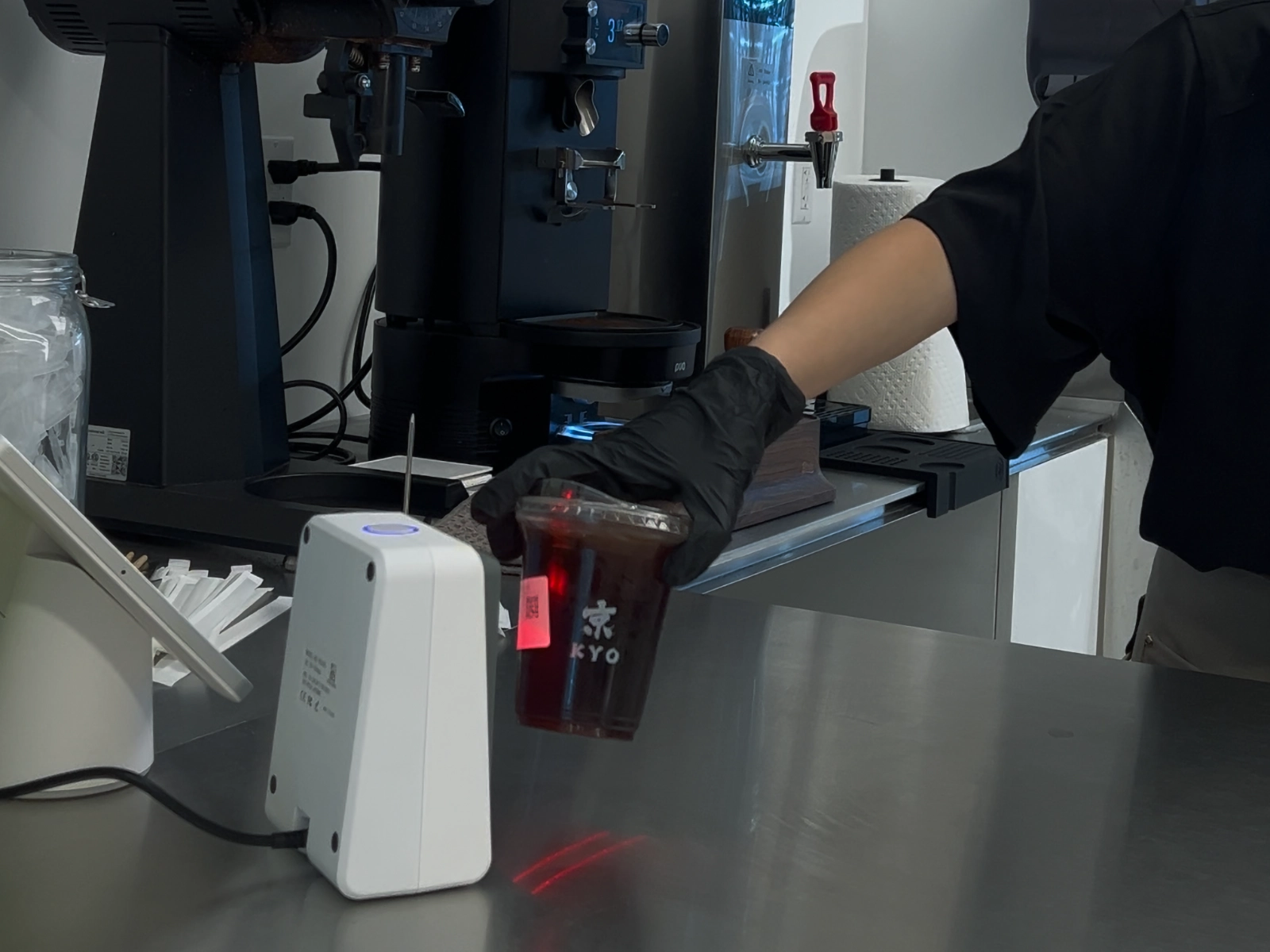 A staff member at KYO scans a QR code for beverage order pickup using MenuSifu’s smart POS solution, ensuring accurate and contactless service during busy hours.