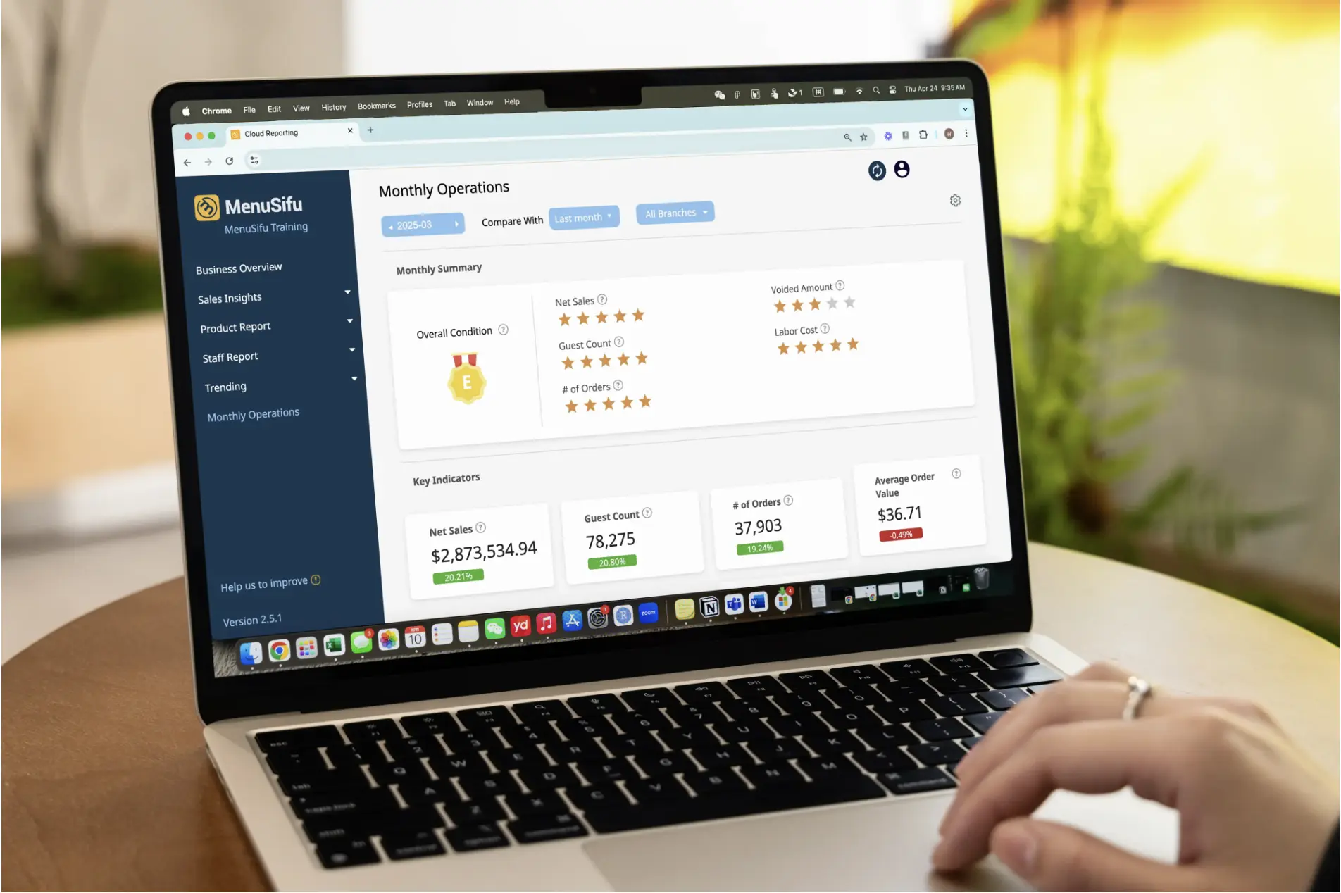 A restaurant owner using the MenuSifu back-office system to view monthly operation data, including sales, orders, and guest performance on a laptop.