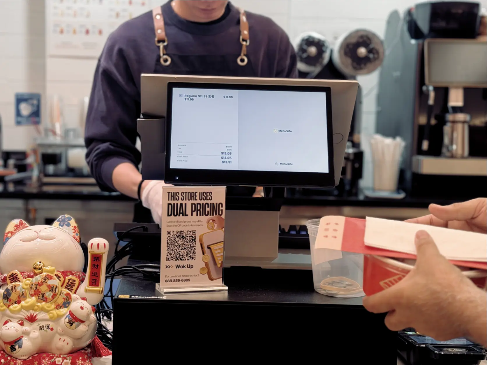 A restaurant cashier operates the MenuSifu POS system to complete customer checkout and process digital payments efficiently.