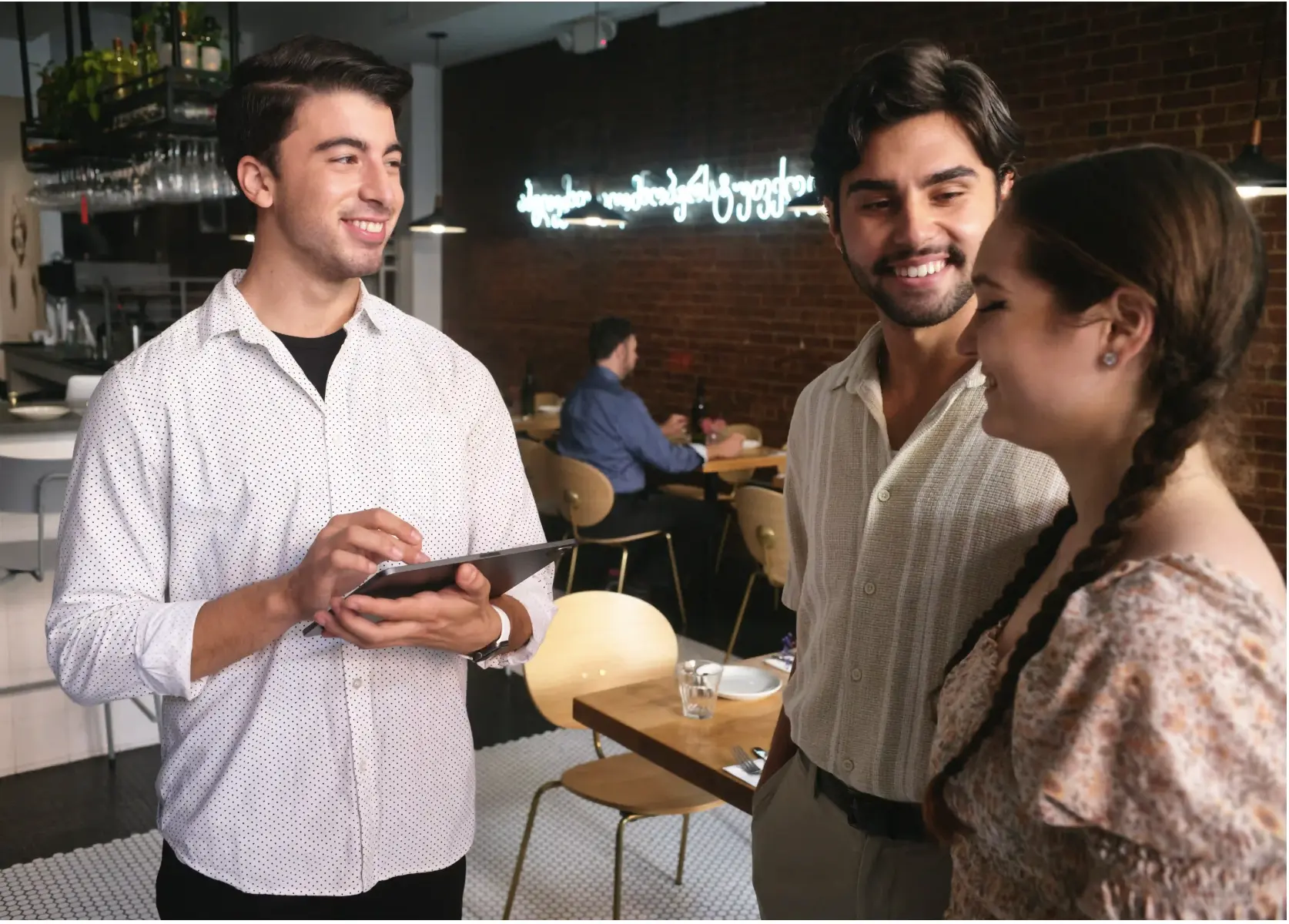 A smiling restaurant server uses the MenuSifu tablet POS system to take guests’ orders and enhance table service efficiency.