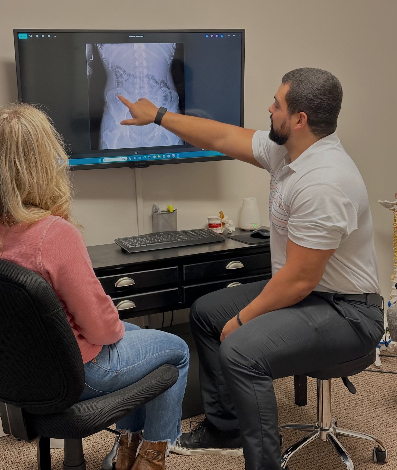 Photo of woman holding her back in pain