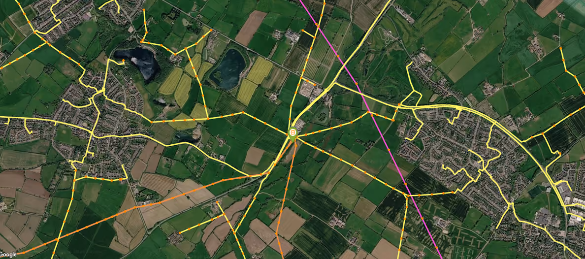Satellite map showing roads and fields with highlighted pathways converging at a central point.
