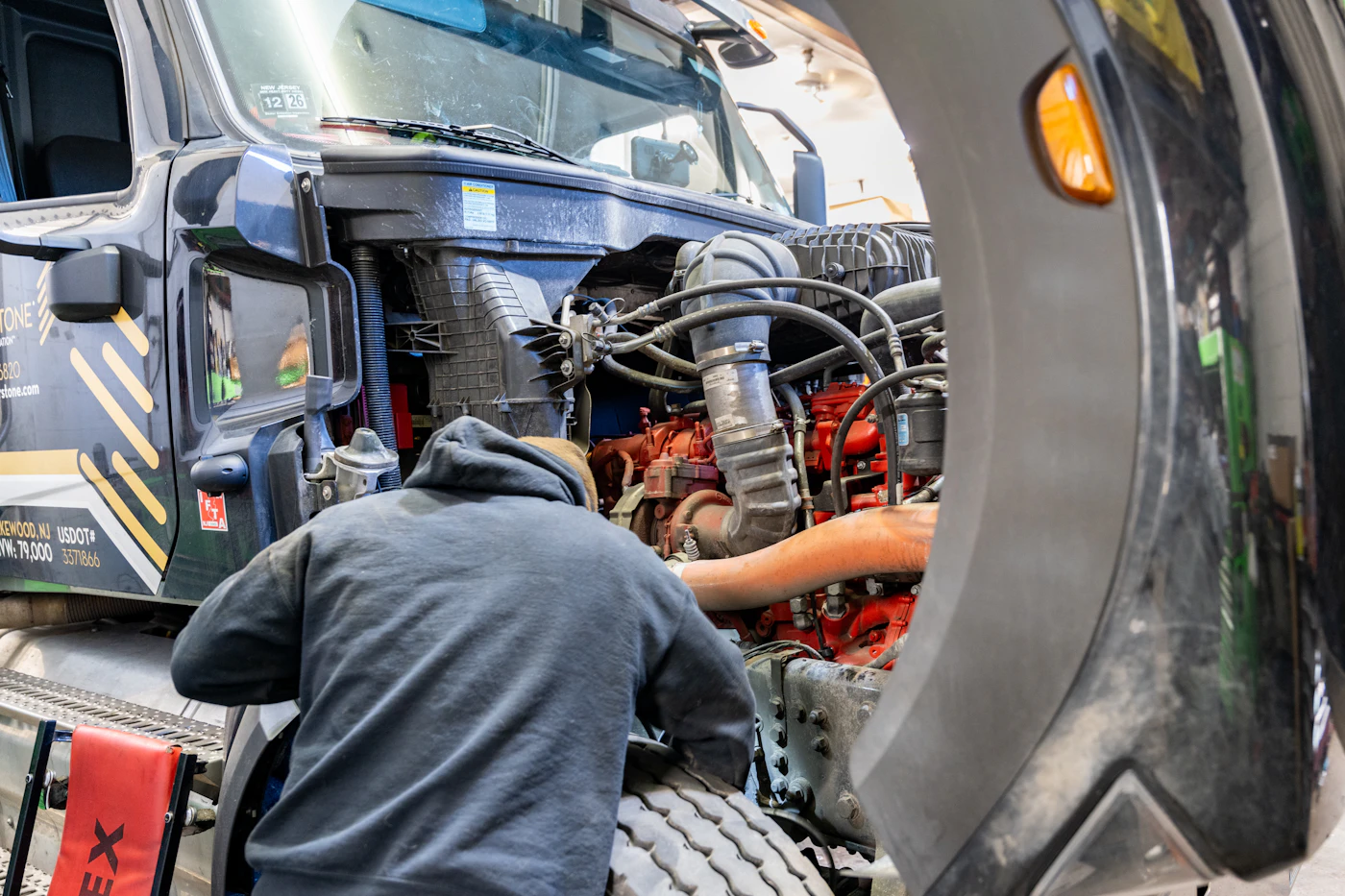 Mobile mechanic performing preventive maintenance service on truck in San Diego
