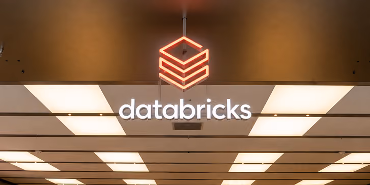 Databricks logo in a modern indoor setting.