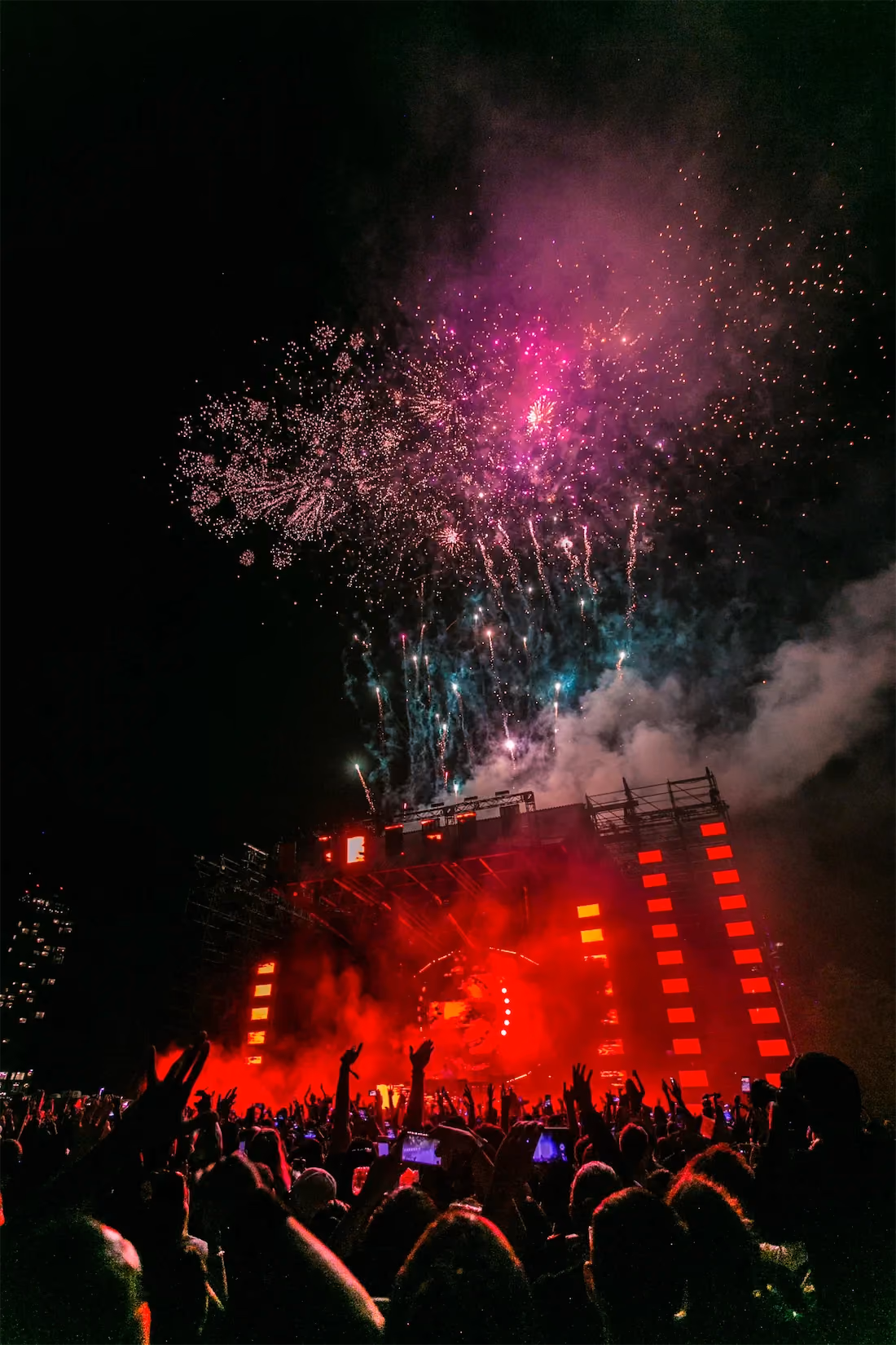 A crowd of people attends a busy concert event