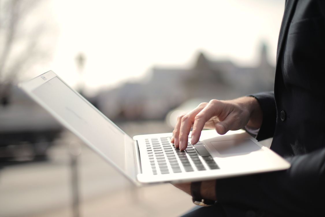 Professional working on a MacBook Air in a minimalist workspace
