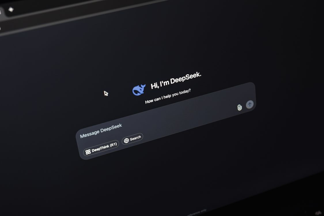 Close-up of a computer screen showing the DeepSeek AI chat interface with a conversation open in dark mode.