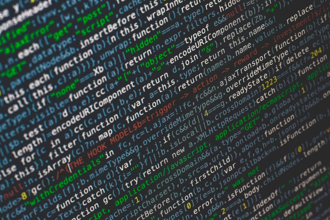 Laptop screen showing highlighted JavaScript code, representing software vulnerabilities and AI-powered exploit discovery.