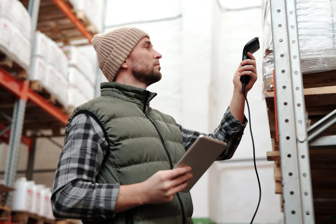 A man navigates a logistics AI app on a tablet