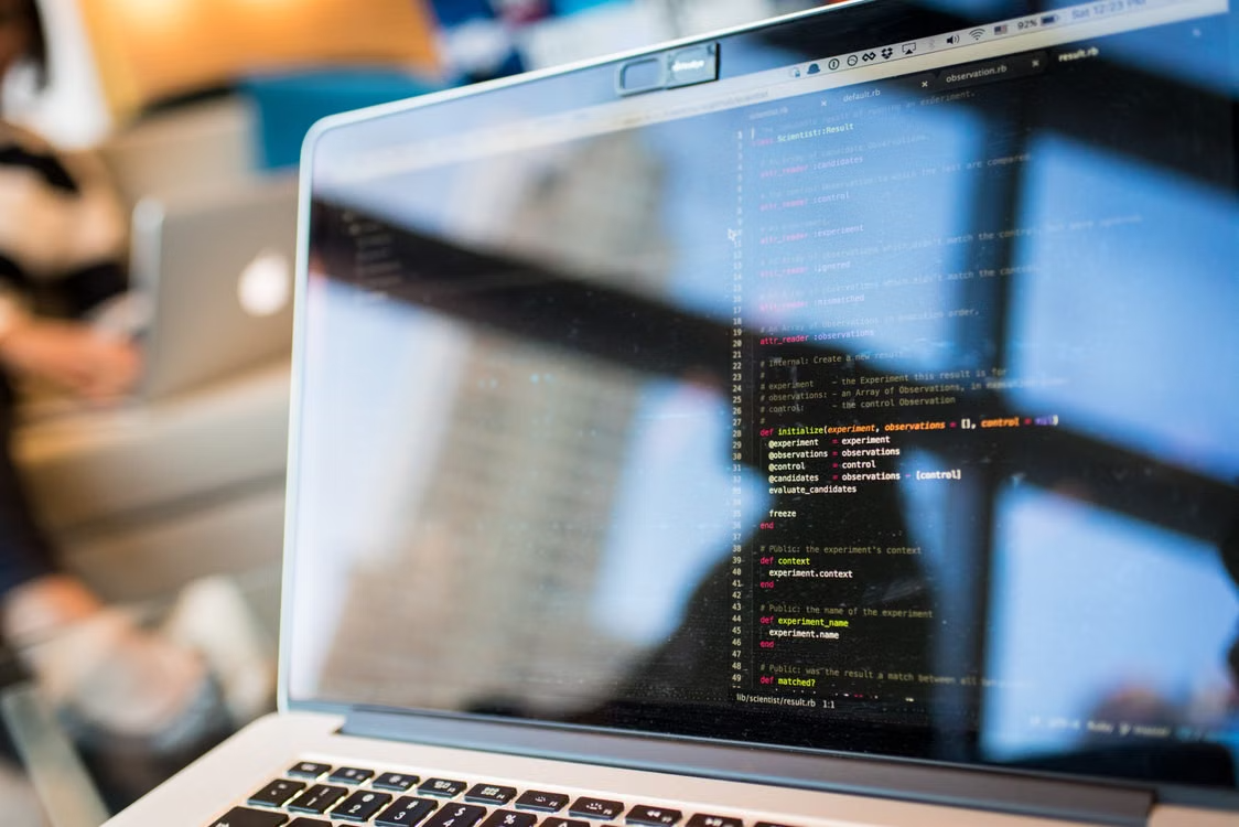 Close-up of software code on a developer’s laptop during AI product development.