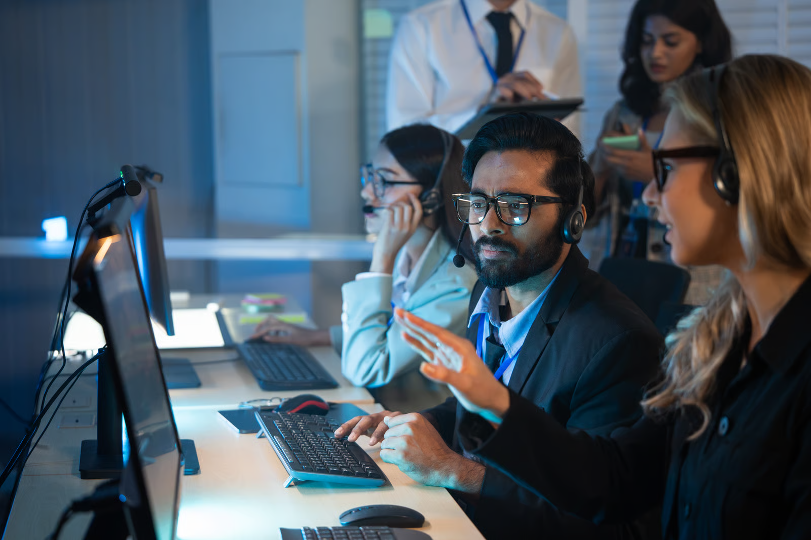 Operations team monitors dashboards and discusses AI-generated requests, illustrating collaborative human review in a high-volume approval workflow.
