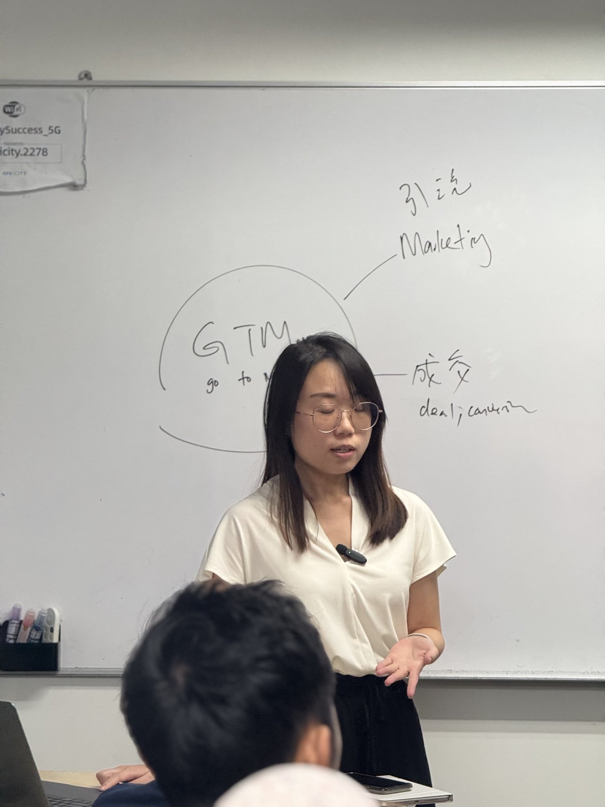 Presenter explaining the go-to-market plan on the whiteboard