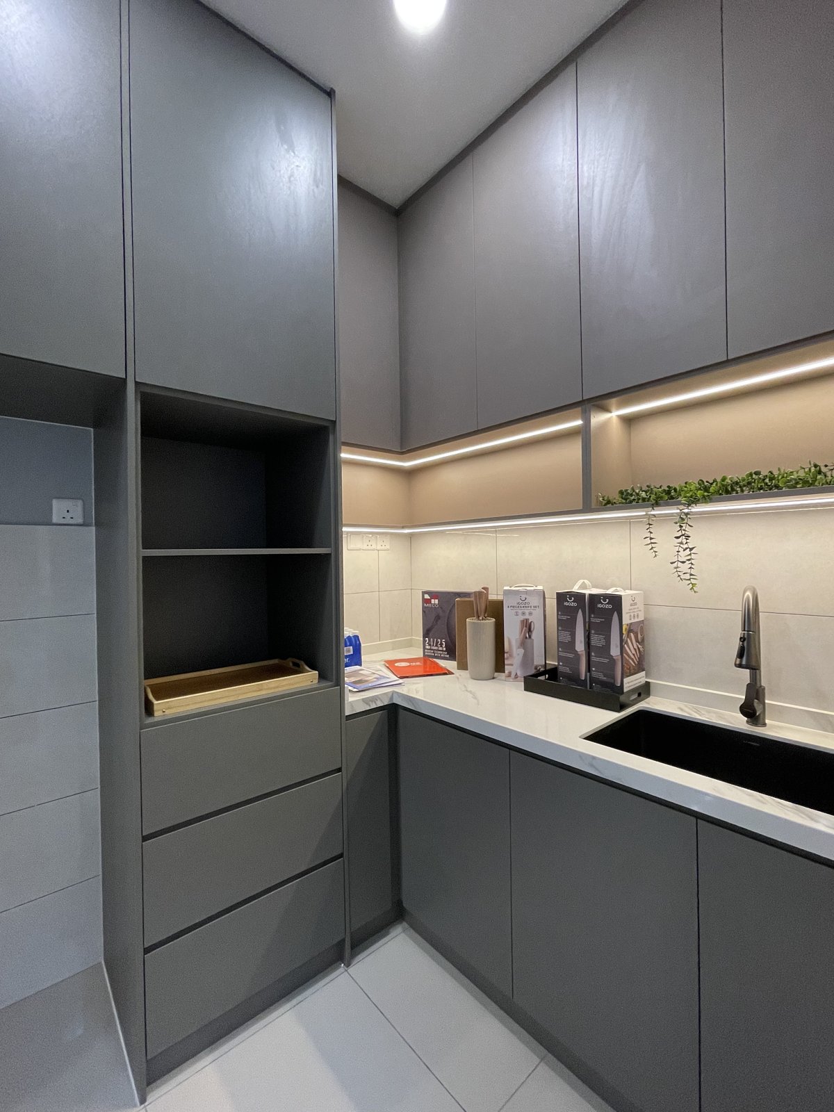 Grey kitchen cabinets with built-in storage at the showroom