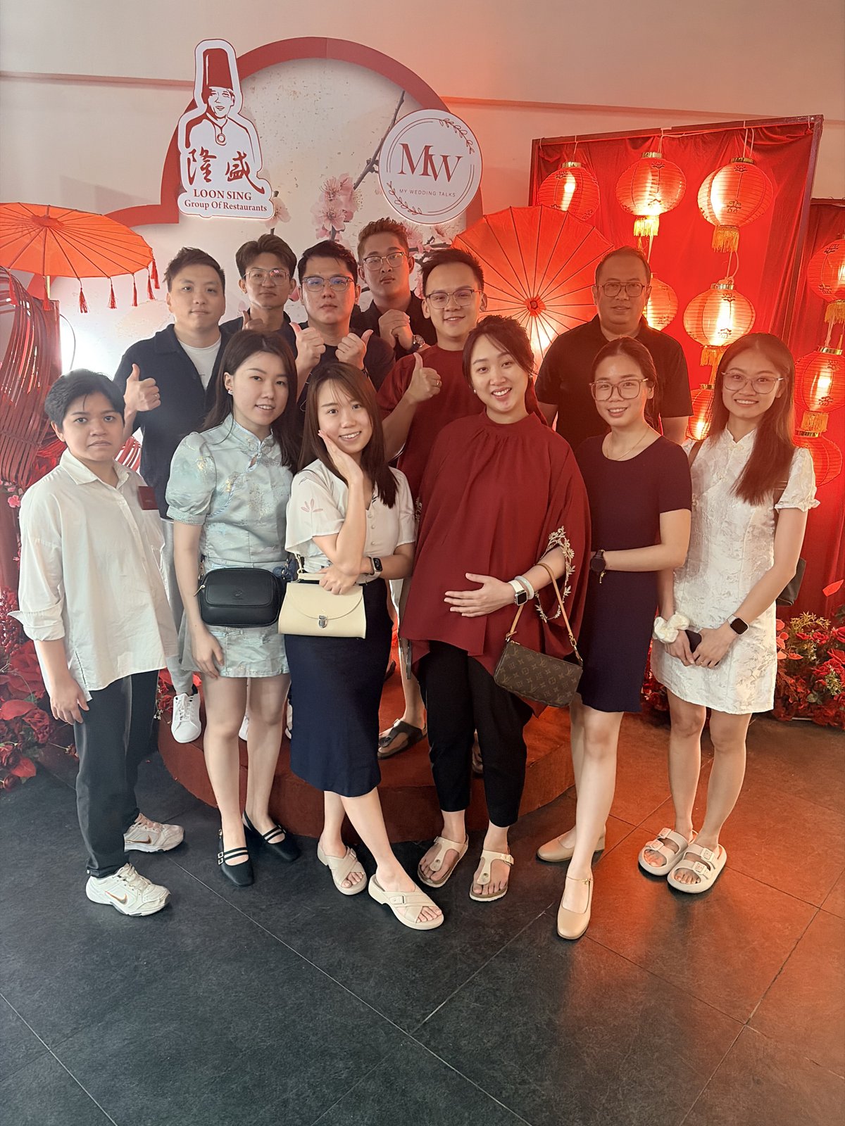 Apricity JB team in front of the CNY backdrop