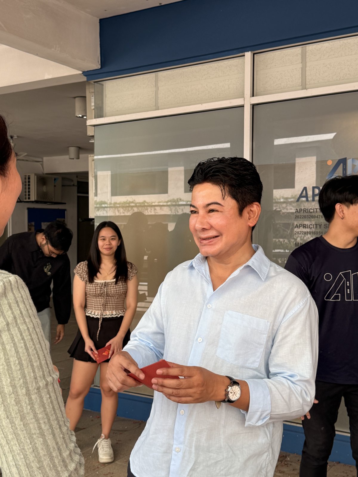 Handing out angpao to the team
