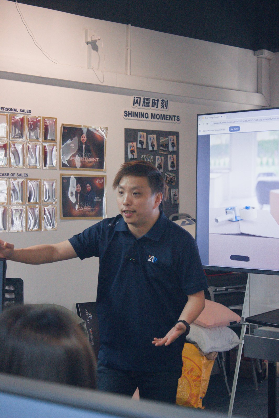 Speaker presenting in front of the Warriotte Wall