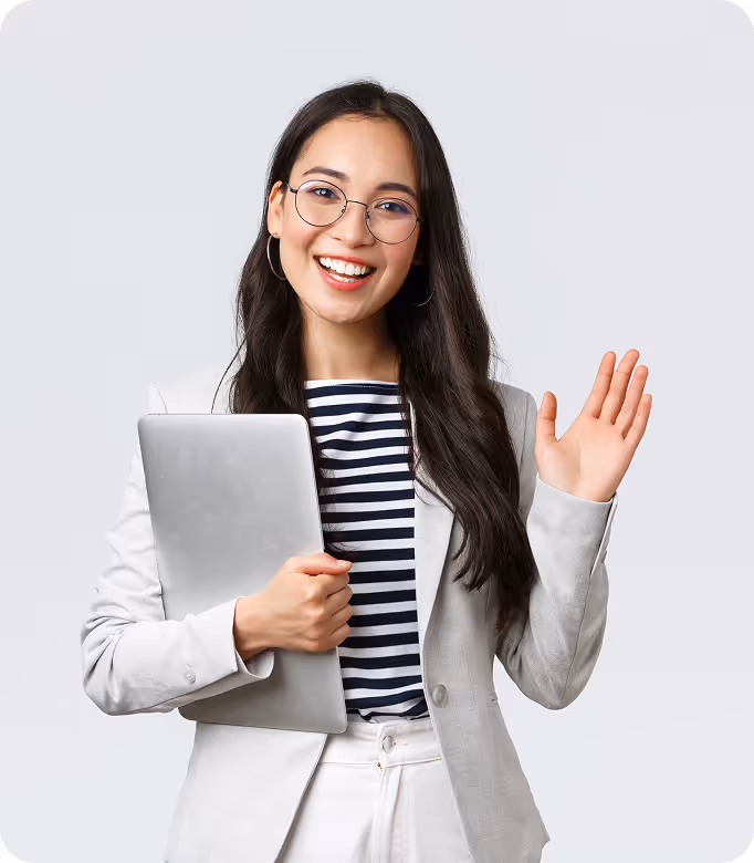 A woman in a suit and tie holding a laptop.