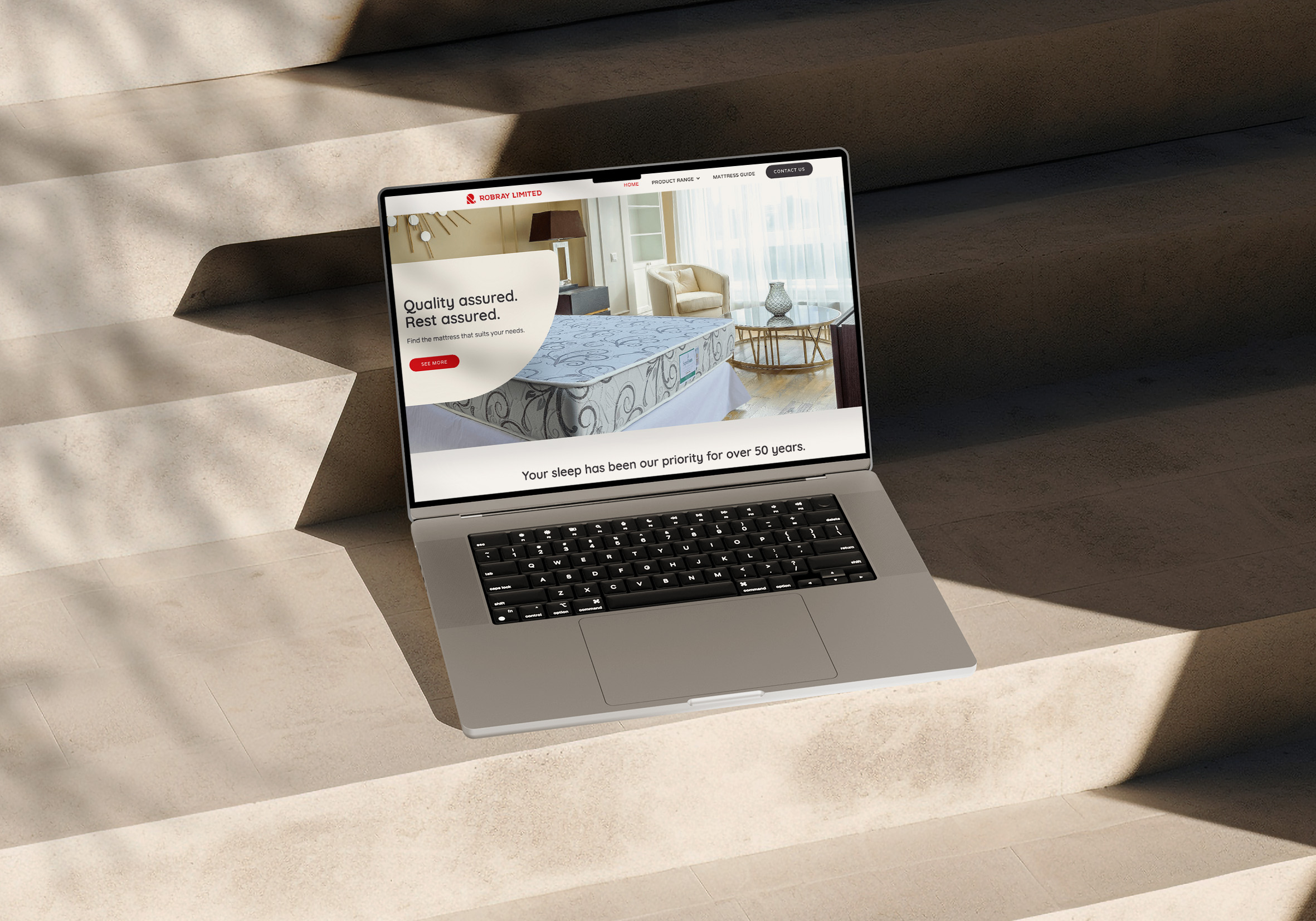 Laptop on steps with a website's homepage displayed