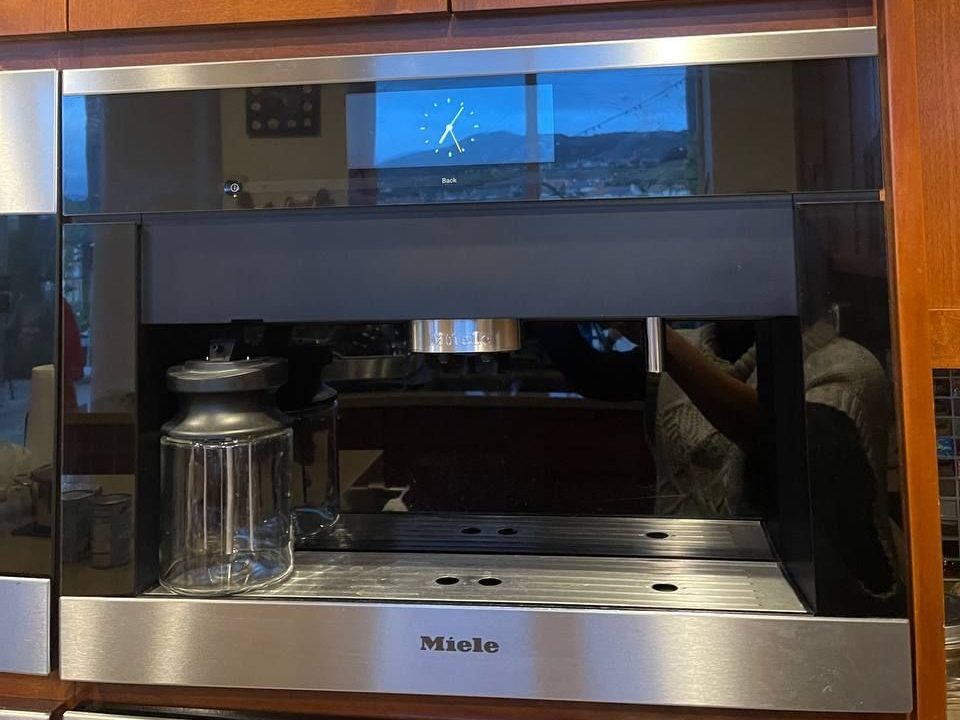 Built-in Miele CVA coffee machine opened for service in a NYC apartment