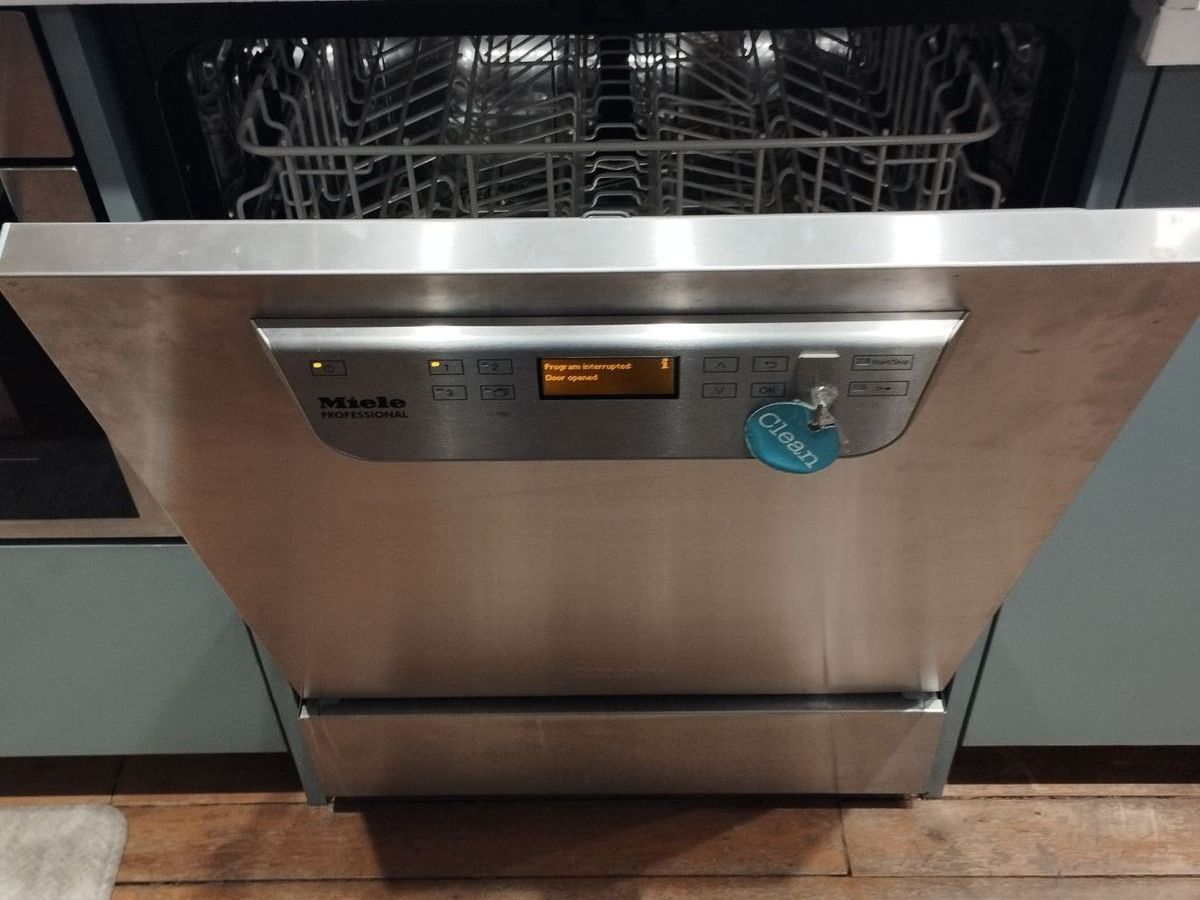 Miele Professional dishwasher with the door open during service