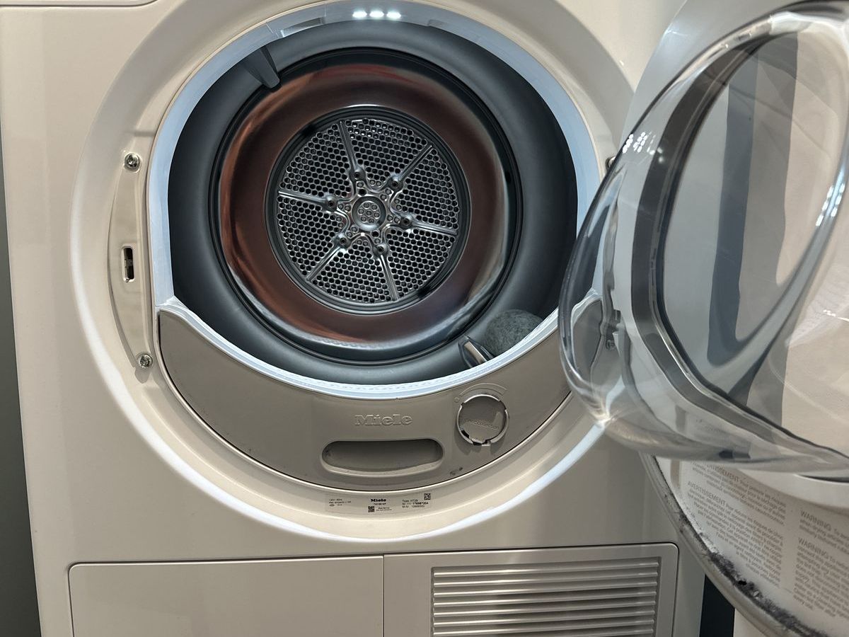 Open drum of a Miele T1 dryer with the lint filter visible