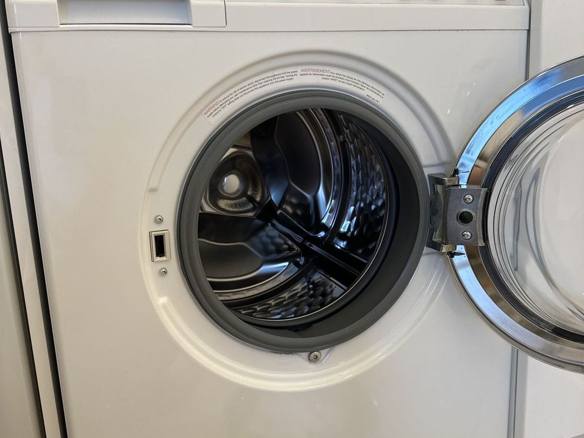 Miele W-series washer with the door open during a door lock repair