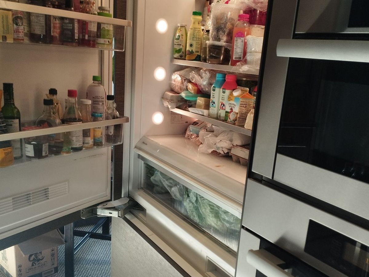Open Miele KF series built-in refrigerator in an NYC kitchen