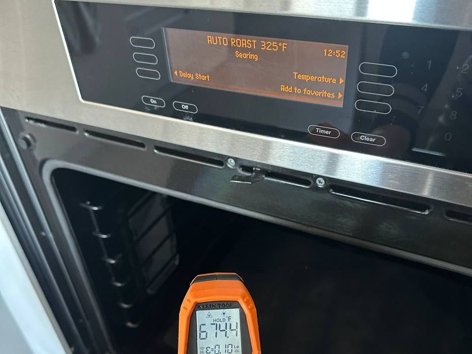 Infrared thermometer reading 674 degrees in a Miele oven set to 325