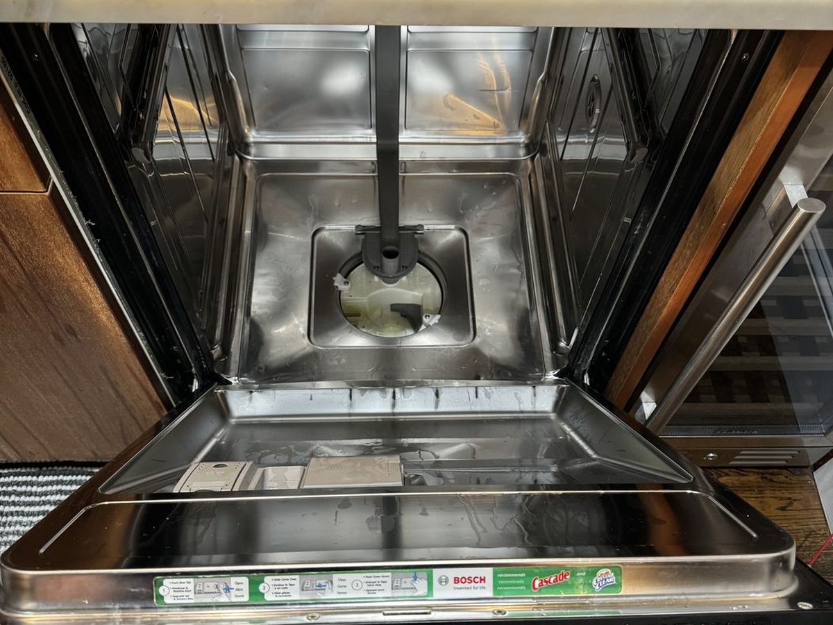 Inside of a Bosch dishwasher tub during a base pan and sump check