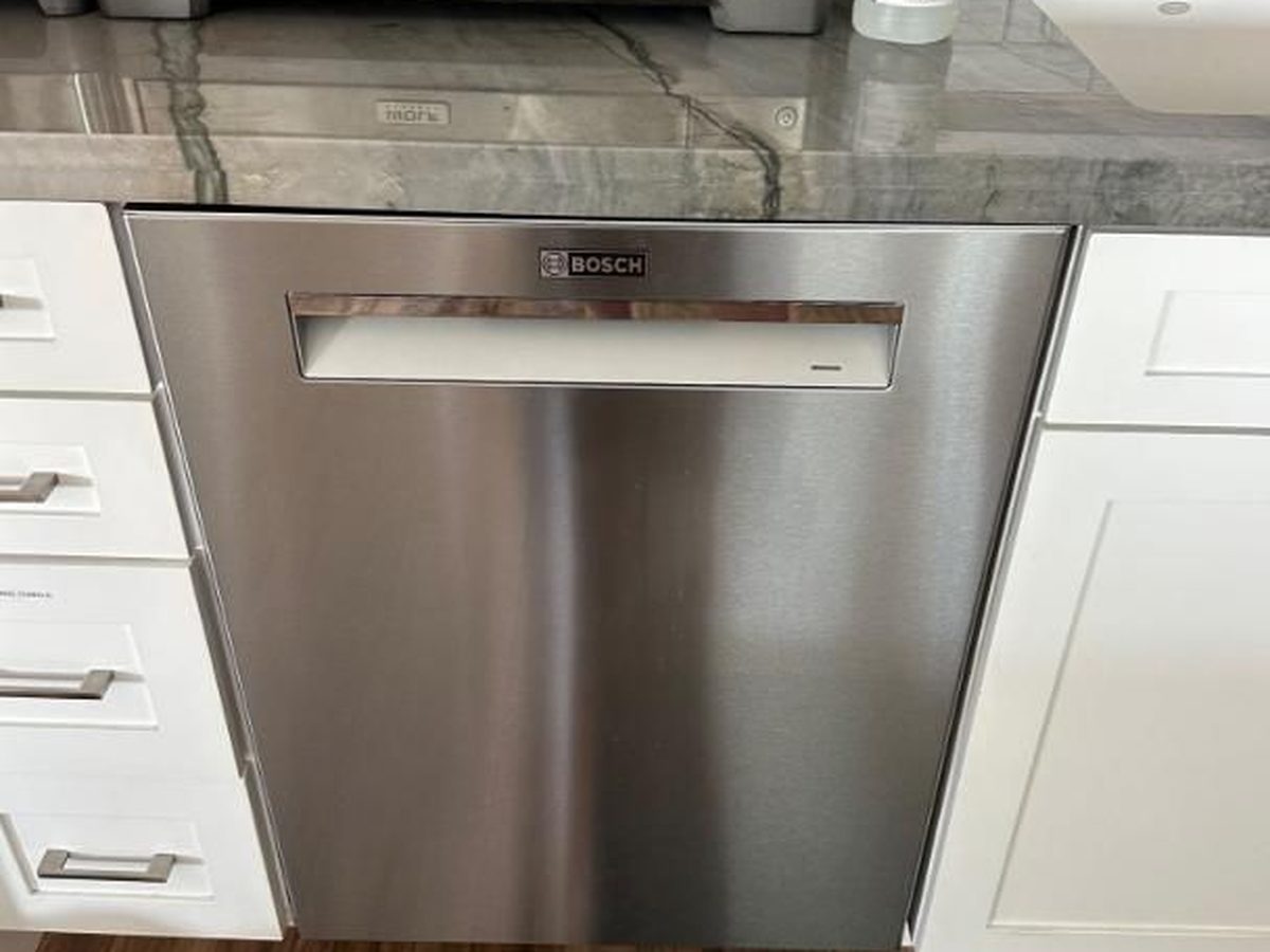 Bosch bar-handle dishwasher installed in a white kitchen