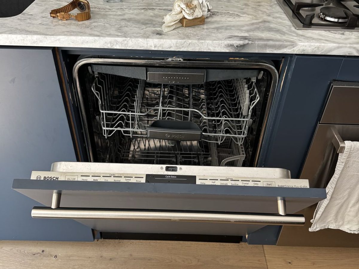 Bosch dishwasher built into blue cabinetry in an NYC kitchen