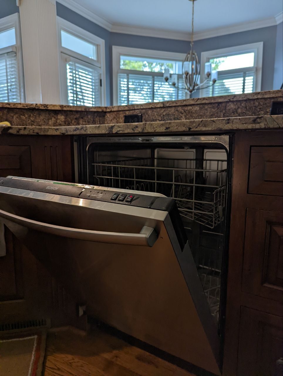 Bosch dishwasher with the door open during a drain service call in an NYC kitchen