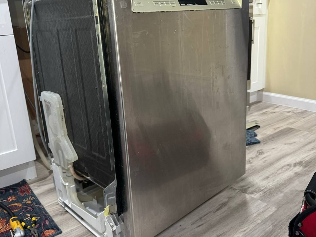 Bosch dishwasher pulled out for access to the drain hose and connections