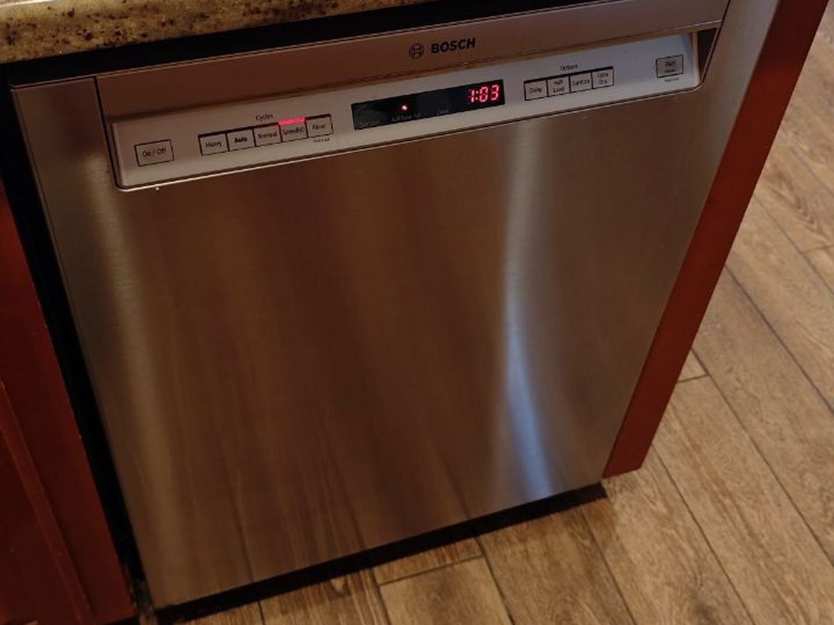Bosch dishwasher mid-diagnosis with racks removed onto the counter