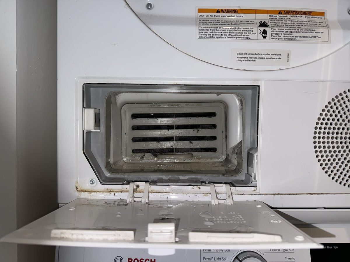 Bosch dryer condenser filter compartment opened with lint buildup visible