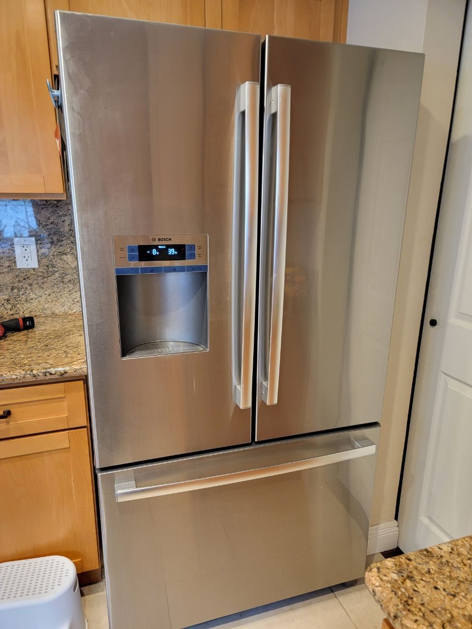 Bosch French door refrigerator with water and ice dispenser in an NYC kitchen