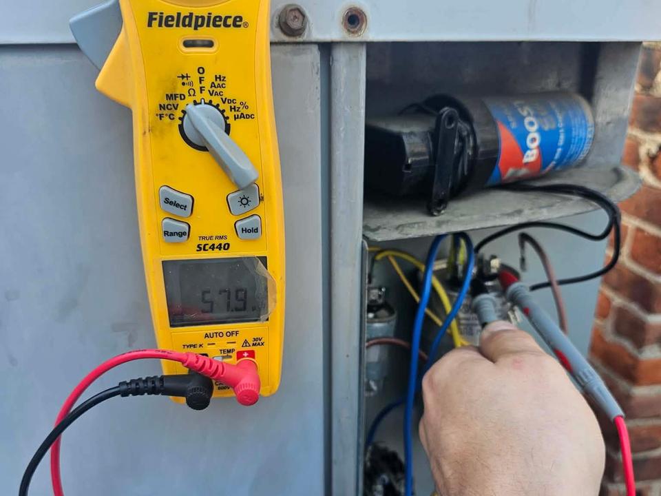 Clamp meter testing AC control wiring during diagnosis