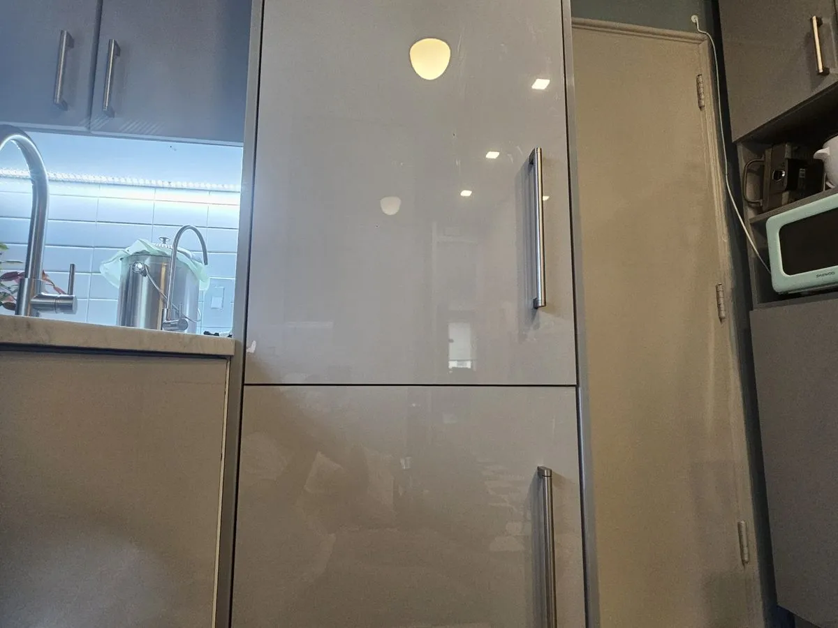 Modern integrated panel-front refrigerator columns in a NYC kitchen